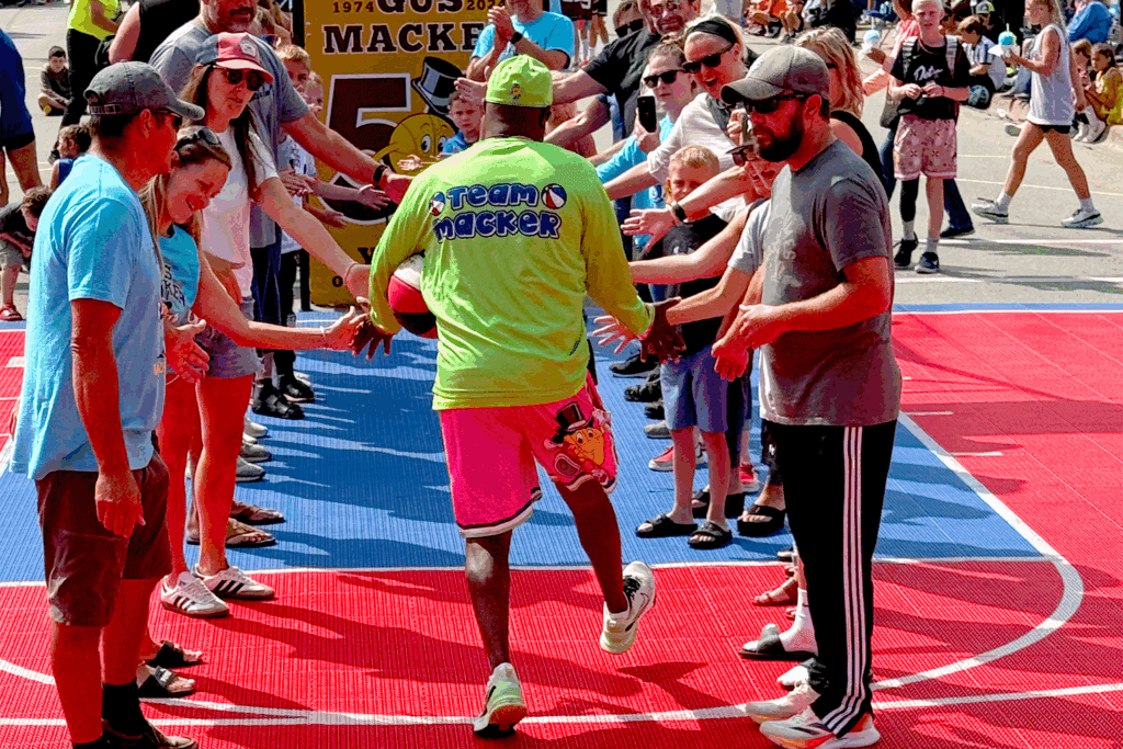Man high-fiving crowd on colorful court